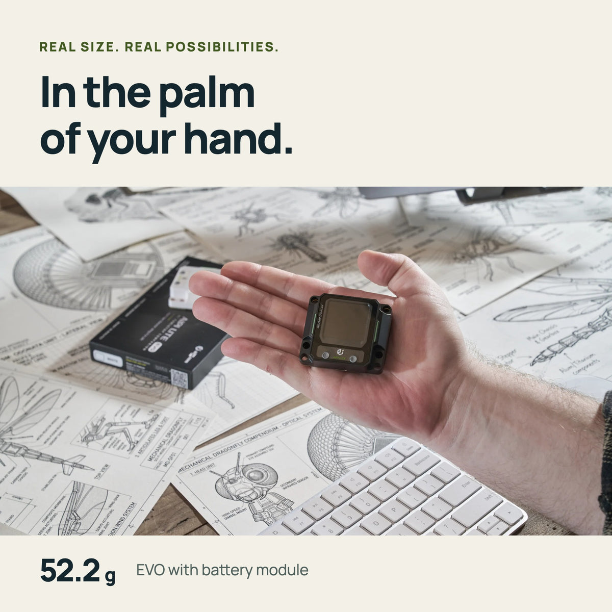 AIPI Lite EVO in the palm of a hand — 52.2 g with battery