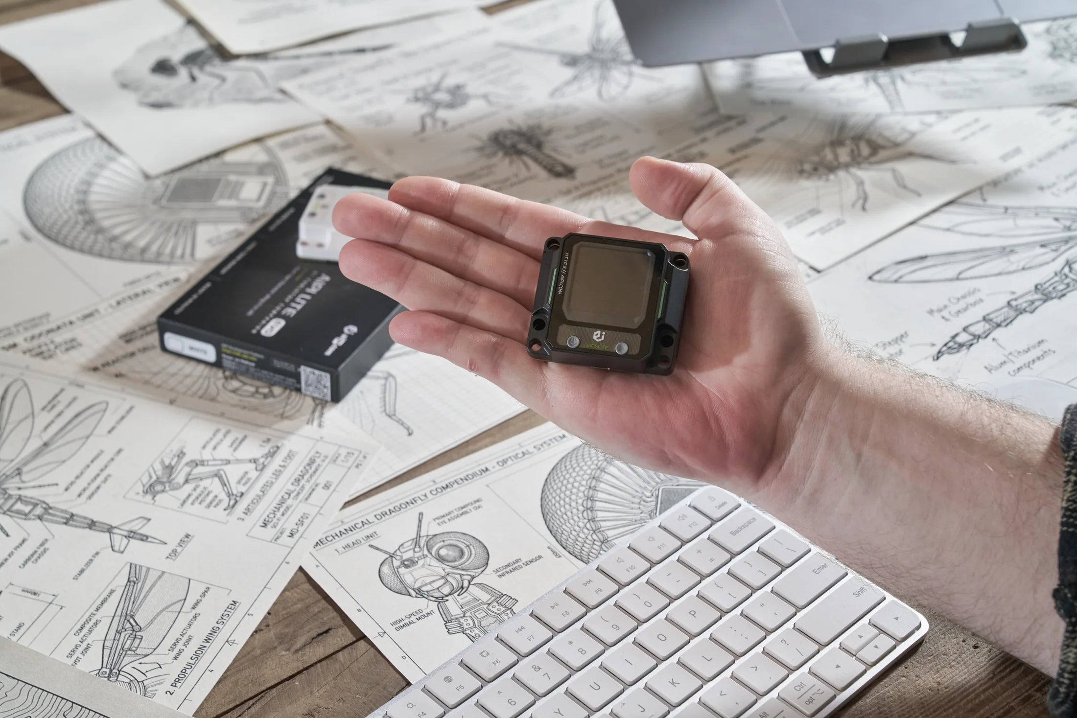 Black AIPI Lite EVO resting in an open palm