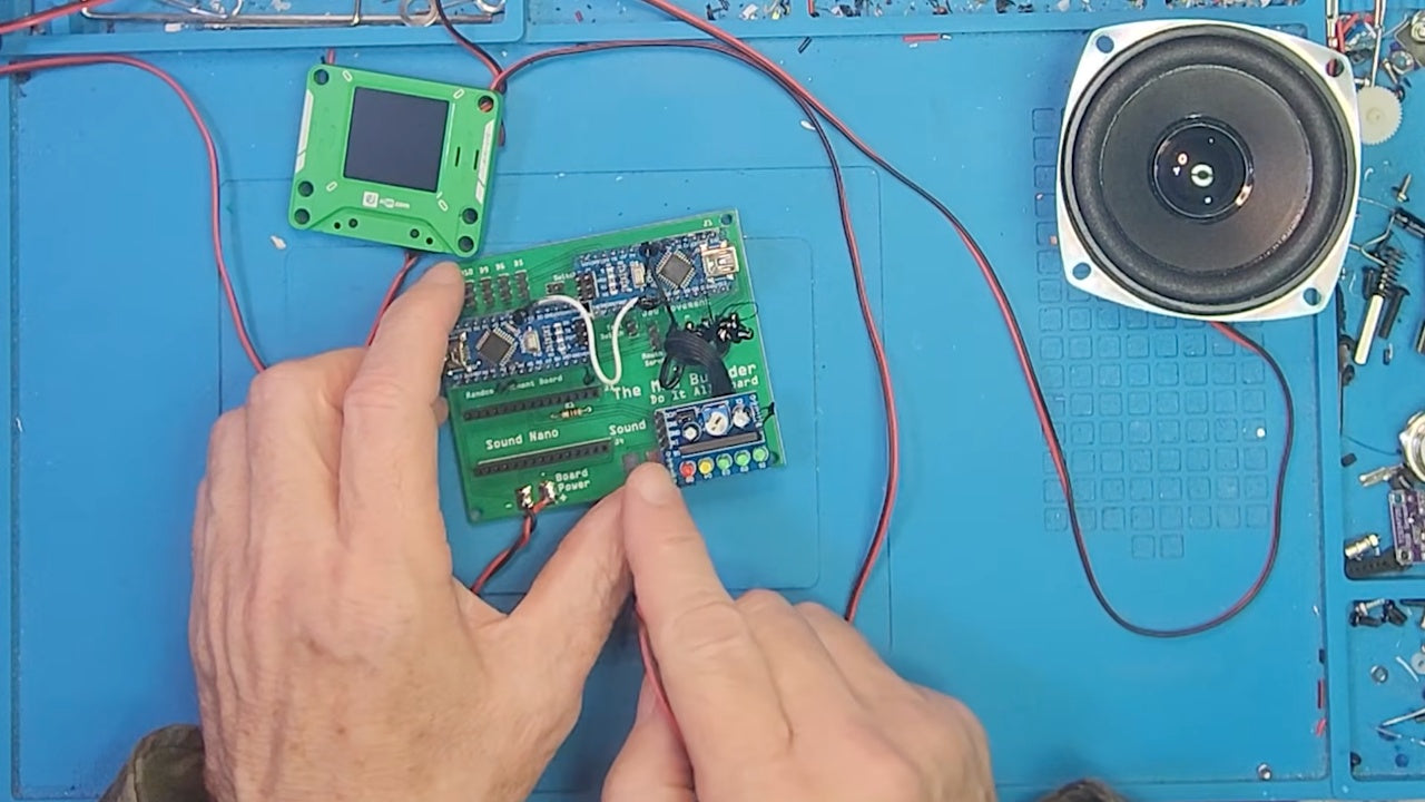 The Mad Builder connecting AIPI Lite, a speaker and an animatronic controller on his workbench